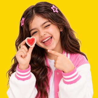 Girl with gummy candy in pop-art composition, yellow background